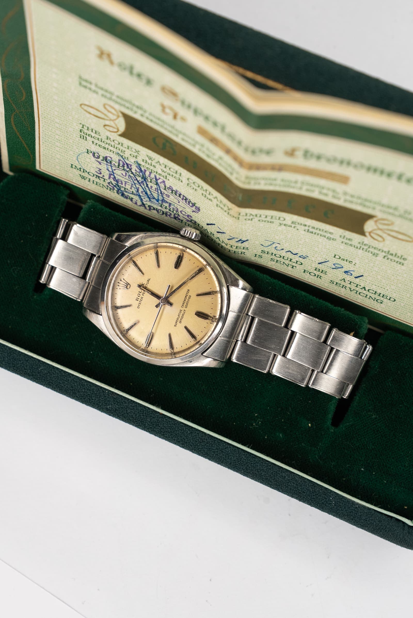 A vintage watch presented with its original box and papers