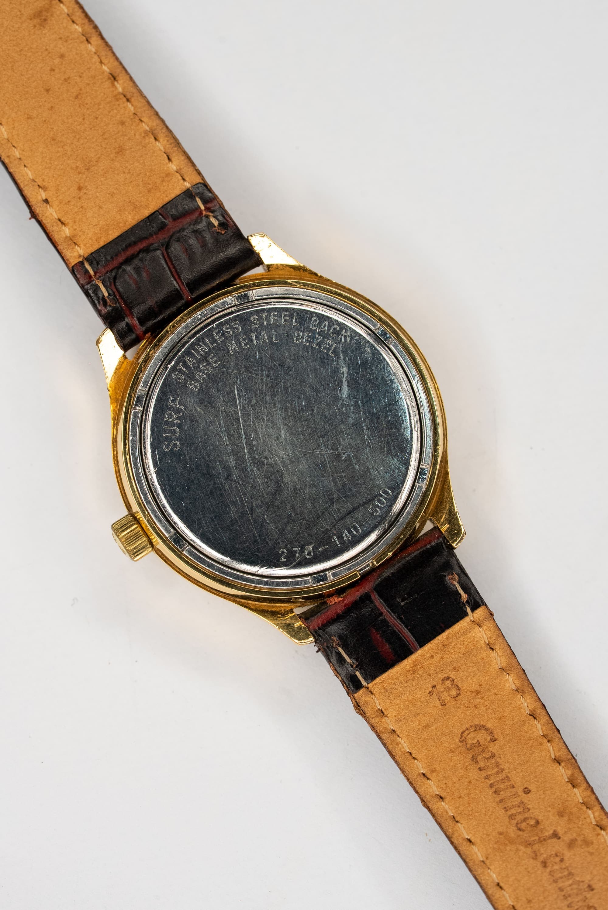 A vintage gold Omega with a linen dial on a leather strap